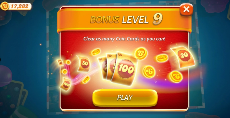 Nivel Bonus în Candy Crush Solitaire. Fundalul nivelului este roșu și cărțile sunt aurii. Butonul de Joacă este de asemenea auriu.
